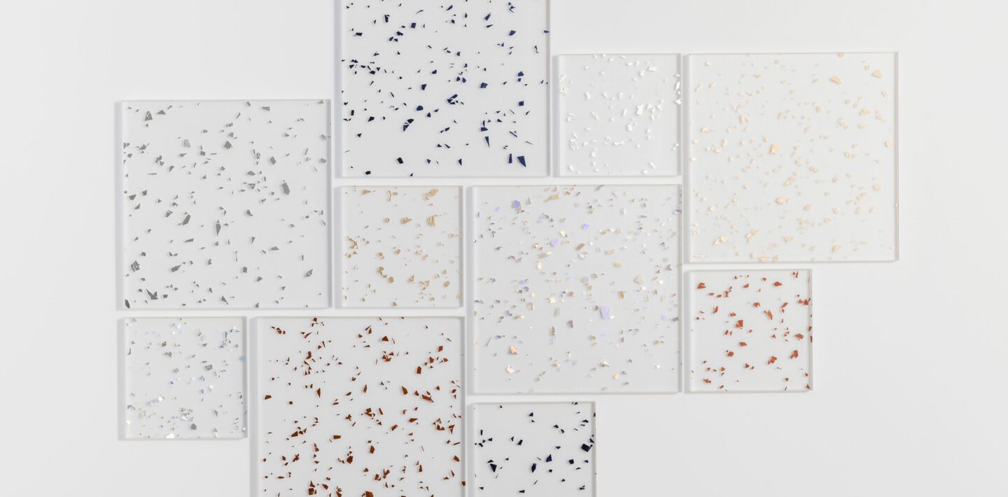Flatlay featuring resin squares of various sizes. Each square contains a different color of metallic flake.