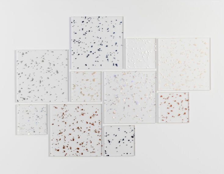 Flatlay featuring resin squares of various sizes. Each square contains a different color of metallic flake.