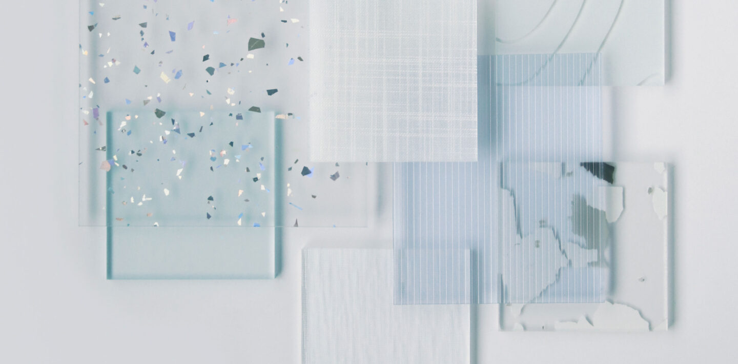 Resin samples of varying sizes, patterns, and colors are layered on top of each other in an asymmetrical composition.