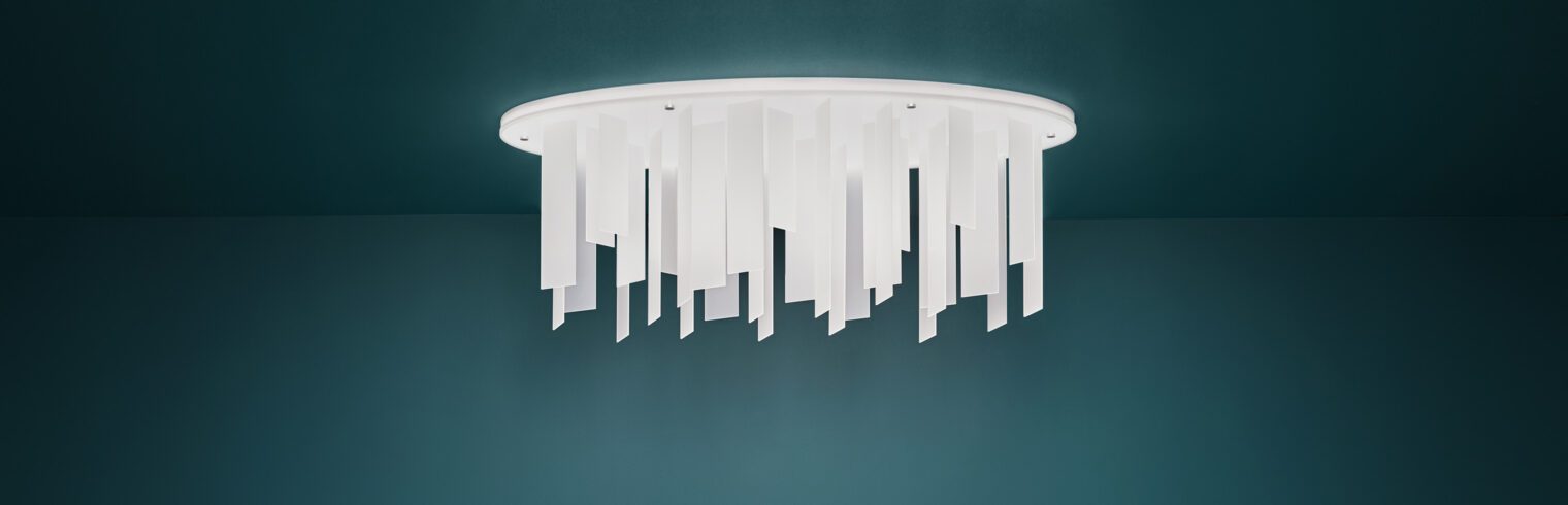 Cova, a modern flush mount light feature, casts a gentle glow of light on a dark room.