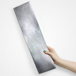A dimensional, rectangular Kuvio tile in the Twist shape and Zinc finish.
