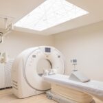 Medical imaging exam room features white rectangular ceiling light secured in place with standoffs.